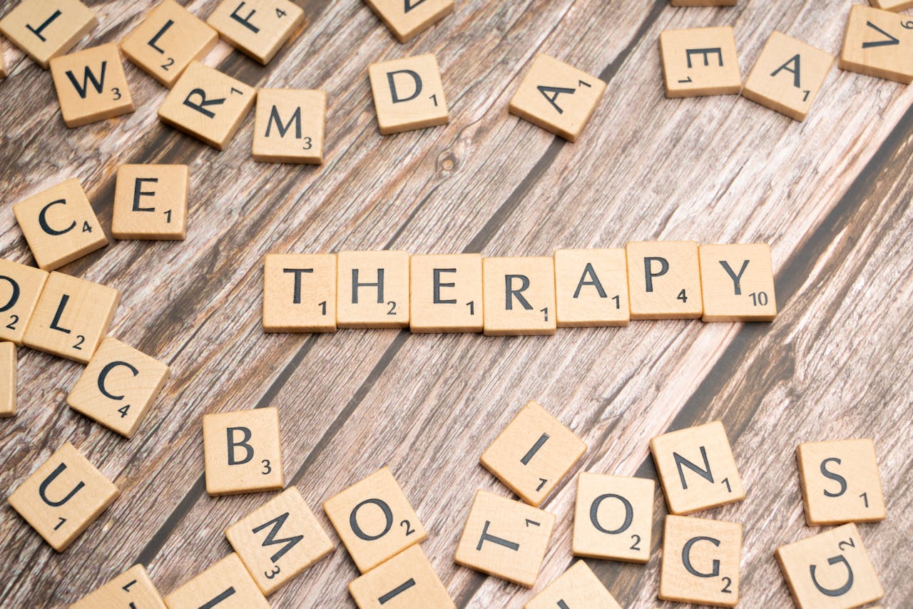 Mastering the First Impression: Your intriguing post title goes here Wooden letter tiles spelling 'therapy' on a wooden background, emphasizing mental health.